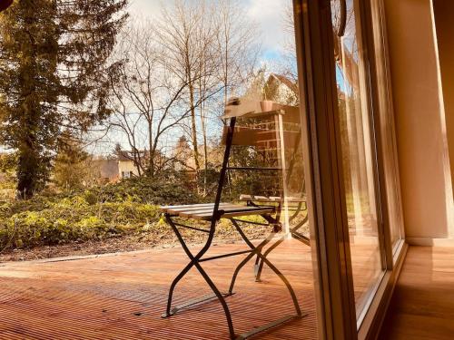 a chair sitting in front of a window at Odw homes - Functional workers apartment with terrace in Weinheim