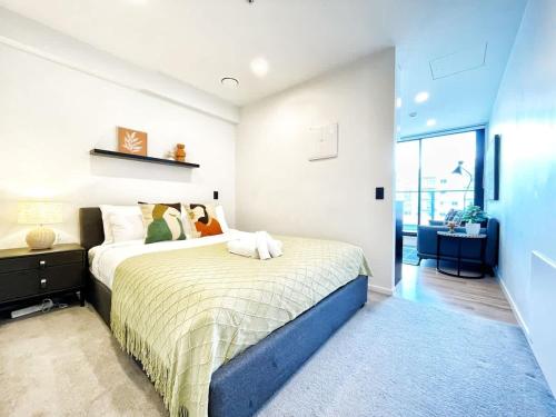 a bedroom with a bed and a large window at Perfect Central Living AC 1 Bed Vs Pool Gym Sauna Near Skytower in Auckland