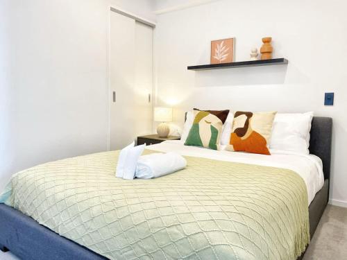 a bedroom with two beds with pillows at Perfect Central Living AC 1 Bed Vs Pool Gym Sauna Near Skytower in Auckland