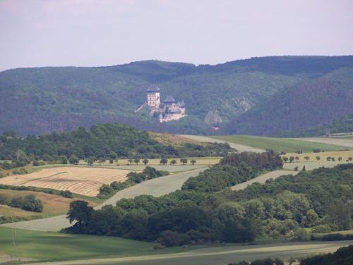 a house on top of a hill with a field at Chalupa Měňany - Karlštejn in Beroun