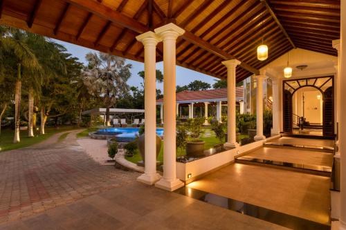 an estate with a swimming pool and a pavilion at Regal Rivera Villa in Negombo
