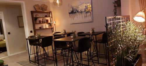 a room with four tables and chairs in it at The Cloudberry Hostel in Näsåker