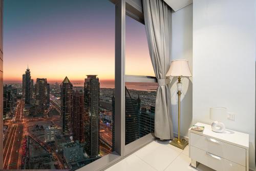 a room with a window with a view of a city at Famous Infinity Pool 64th floor near Burj Khalifa in Dubai