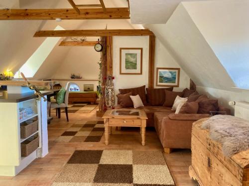 a living room with a couch and a table at Fewo ODIN by fewo-plan GALM100 an der Nordsee bei Dagebüll in Galmsbüll