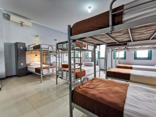 a group of bunk beds in a room at Populair Hostel Braga in Bandung