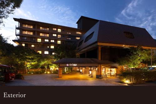 a large building with a parking lot in front of it at Yamanaka Onsen Kissho Yamanaka in Kaga