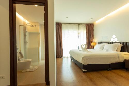 a bedroom with a bed and a bathroom with a shower at V69 15min Convenient to Patong Building Gym in Kamala Beach