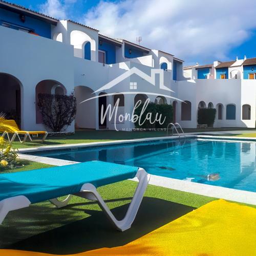 a swimming pool in front of a villa at Ses Orenetes in Cala en Blanes