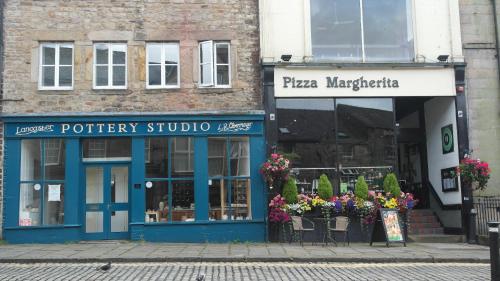 a store with blue doors on a city street at Newly Renovated 3 Bedroom House, 6 beds with 2 showers, near University Town Centre in Lancaster
