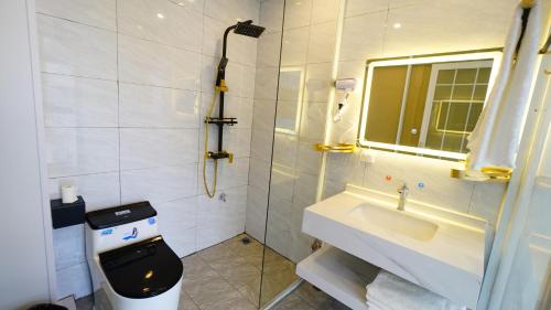 a bathroom with a toilet and a sink and a mirror at Yibuxuan Boutique Hotel Yangshuo in Yangshuo