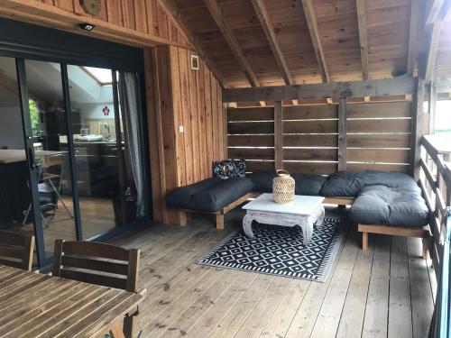 a living room with a couch and a table at Le Loft in Lacanau