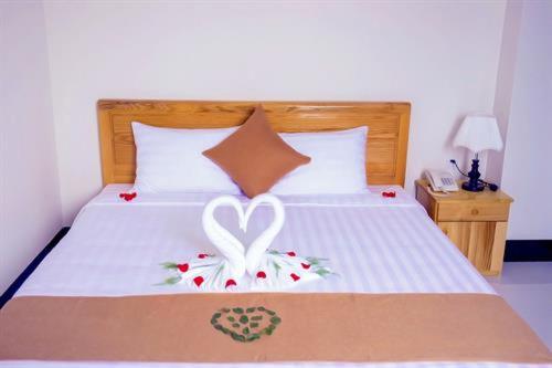 a bed with a heart painted on it with flowers at Biển Nhớ Hotel & Coffee in Phan Thiet