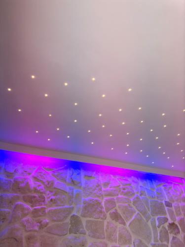 a room with a rock floor and purple lights at Pharus Miseni Suites and rooms in Bacoli