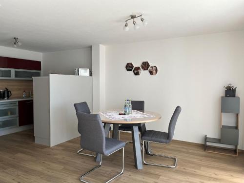 a kitchen and dining room with a table and chairs at Ferienwohnung Haus Brenner in Seeg