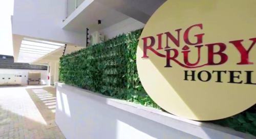 a building with a green wall with a ring riley hotel at Ringruby Hotel, Oduduwa Way in Ikeja