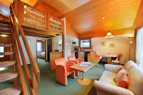 a living room with a couch and a bunk bed at Apartments Kirchbühl in Grindelwald