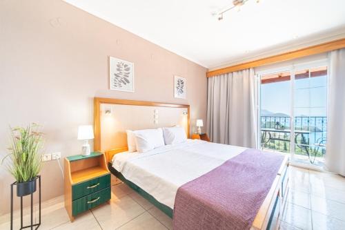 a bedroom with a bed and a large window at Spyridoula Studio 11 in Paleokastritsa