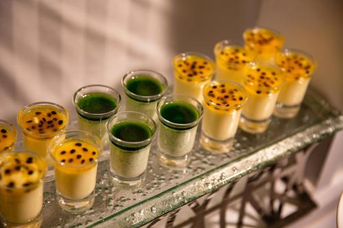 a group of glass cups with ingrediants on a table at Hanoi Fiesta Central Hotel and Spa in Hanoi
