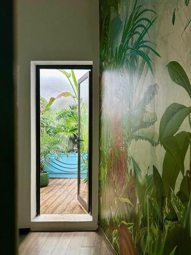 a mirror in a room with a painting on the wall at Old Quater Tropical House in Noi Bai