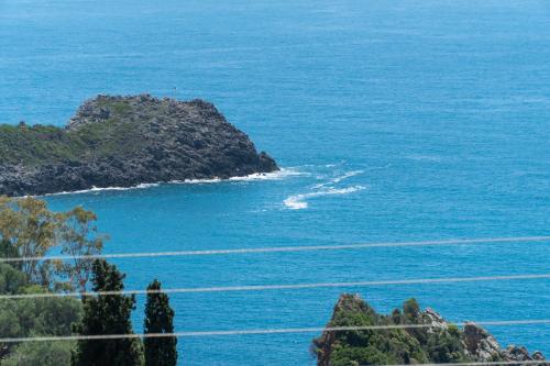an island in the ocean next to a body of water at Spyridoula Studio 1 in Paleokastritsa