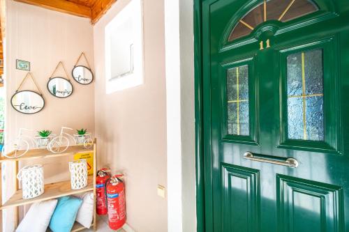 a green door in a bathroom with towels at Spyridoula Studio 1 in Paleokastritsa