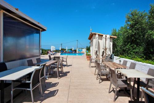 a row of tables and chairs on a patio at Zante View Family Studio 2 in Tsilivi