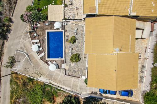 an overhead view of a yellow building with a pool at Spyridoula Studio 2 in Paleokastritsa