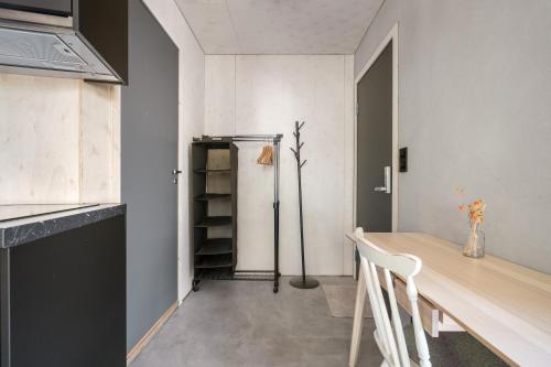 a dining room with a table and a refrigerator at Architectural Studio I Private Balcony I NEW 2021 in Bergen