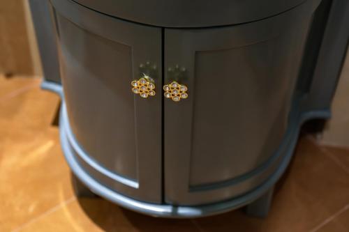 a black cabinet with gold earrings on it at Hanoi Fiesta Central Hotel and Spa in Hanoi