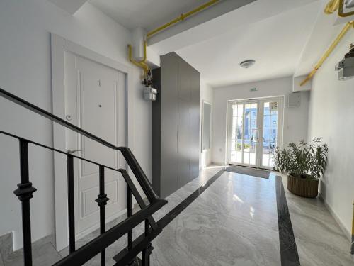 an empty hallway with a staircase in a building at COLLINE Rezidențial in Rediu