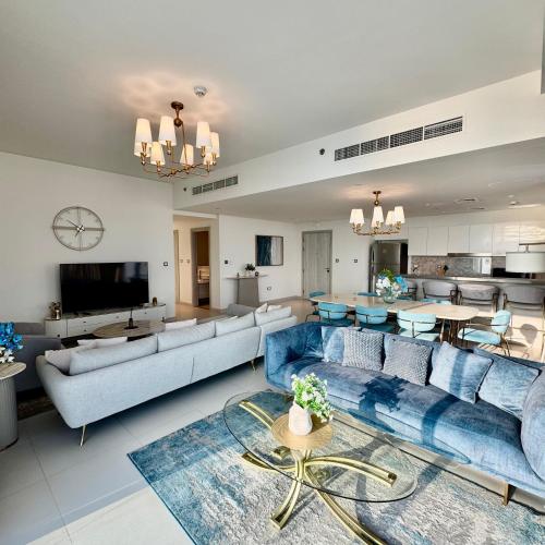 a large living room with couches and a dining room at THE COVE Creek Harbour in Dubai
