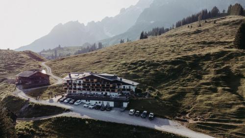 an aerial view of a building on a mountain at Alpengasthof-Hotel Kopphütte in Mühlbach am Hochkönig
