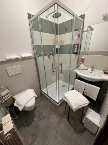 a bathroom with a shower and a toilet and a sink at Agriturismo Palazzo Bandino - Wine cellar, on reservation restaurant and spa in Chianciano Terme