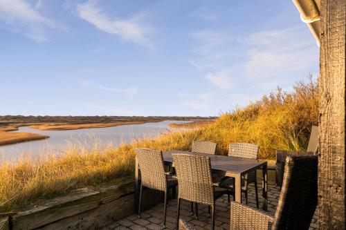 a table and chairs with a view of a river at Bjålum in Nørre Nebel