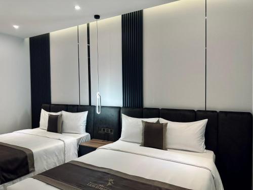 two beds sitting next to each other in a room at LION 15 Hotel in Can Tho