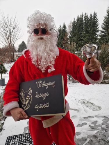 a man dressed as santa claus holding a sign at Wilczarz in Duszniki Zdrój