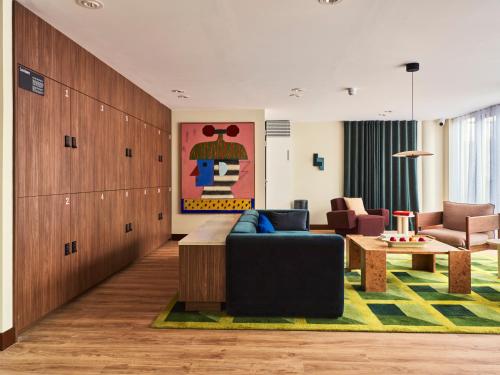 a living room with a couch and a table at Numa The Hague Scheveningen in Scheveningen