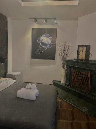 a bedroom with a bed with two towels on it at Porta Hostel in Batumi