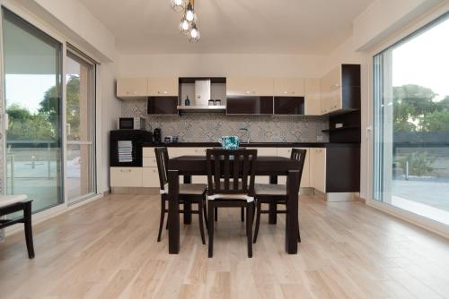 a kitchen and dining room with a table and chairs at CHIALE Holiday Villa in Polignano a Mare