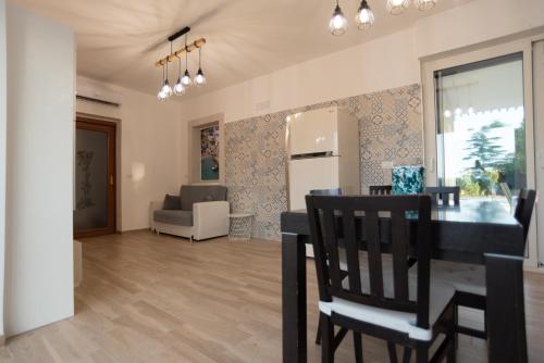 a dining room and living room with a table and chairs at CHIALE Holiday Villa in Polignano a Mare
