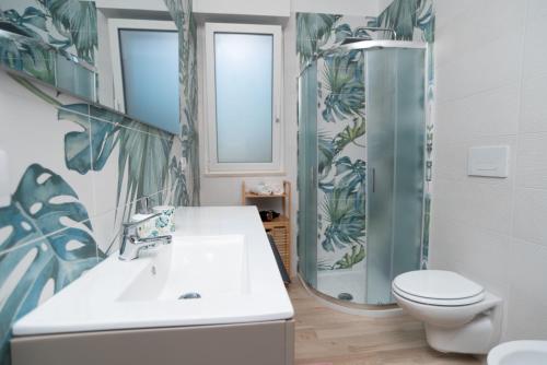 a bathroom with a sink and a toilet and a shower at CHIALE Holiday Villa in Polignano a Mare