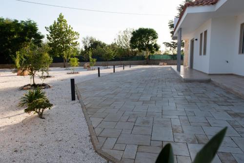 a courtyard of a house with a stone driveway at CHIALE Holiday Villa in Polignano a Mare