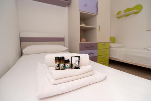 a bedroom with two beds with towels and cosmetics at CHIALE Holiday Villa in Polignano a Mare