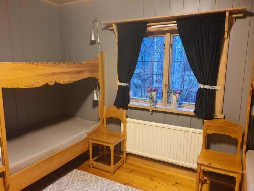 a bedroom with two bunk beds and a window at Mora Life, Åmåsängsgården in Mora