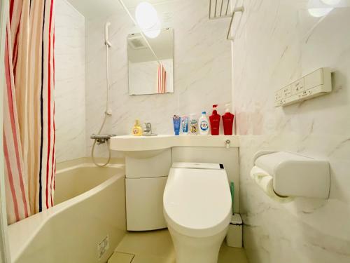 a bathroom with a toilet and a sink and a bath tub at Okubo House 3F SJ0277 in Tokyo