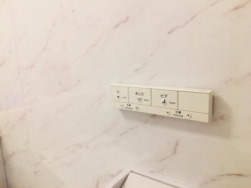 a white marble wall with a shelf in a bathroom at Okubo House 3F SJ0277 in Tokyo