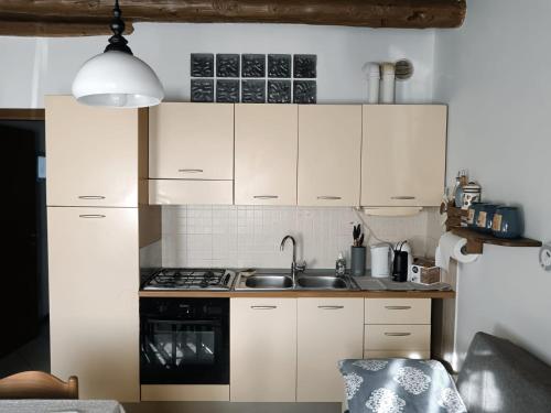 a kitchen with white cabinets and a sink at Casa Giulia - Valeggio sul Mincio in Valeggio sul Mincio