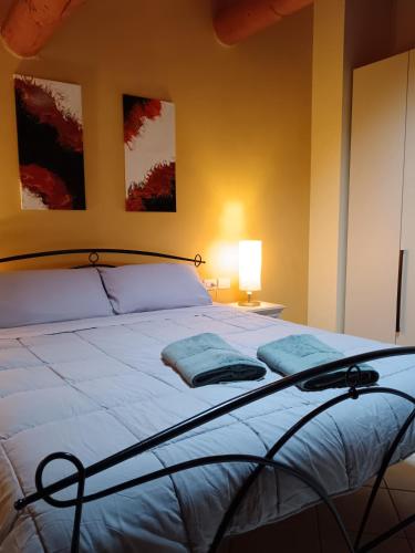 a bedroom with a bed with two pillows on it at Casa Giulia - Valeggio sul Mincio in Valeggio sul Mincio