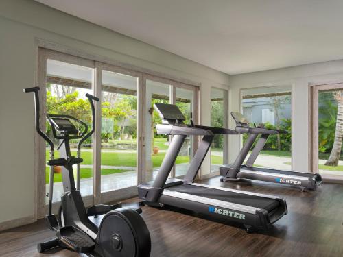 two exercise bikes in a room with windows at Sudamala Resort, Sanur, Bali in Sanur