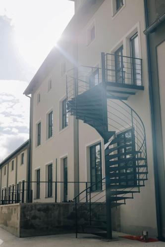 a building with a spiral staircase on the side of it at Plavírna in Otovice